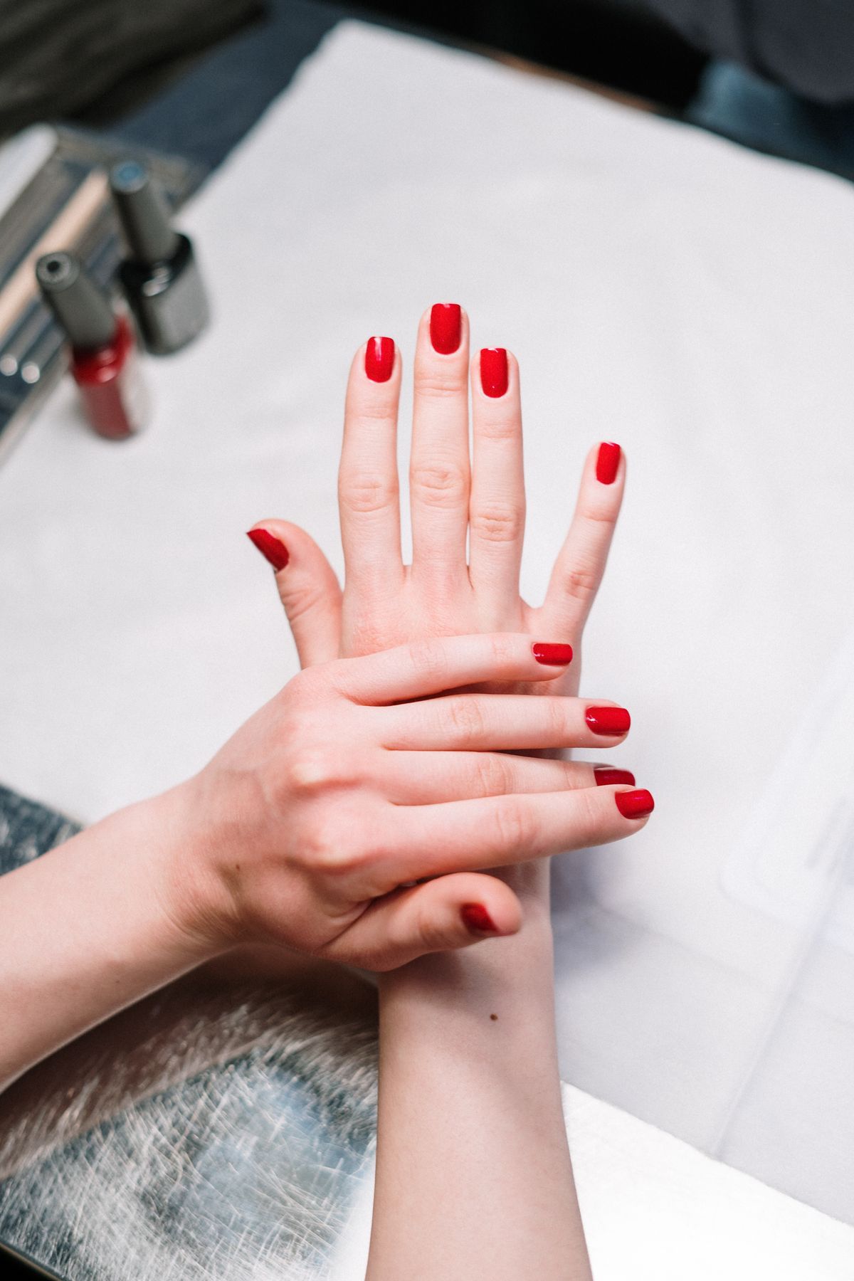 Glossy red gel manicure, a nail style available at Pretty Lit Nail Bar