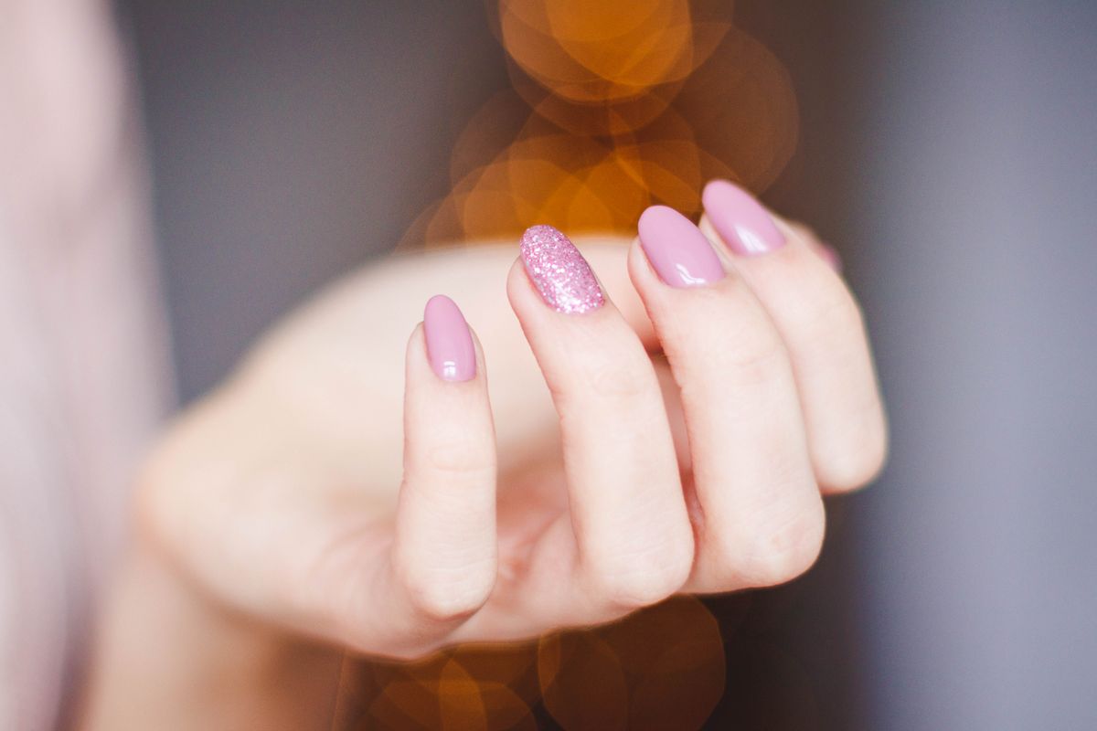 Pink glitter accent nail design, representing custom nail art at Pretty Lit Nail Bar
